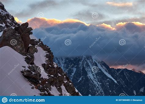 Sunset In Mountains Reflection Of Red Sun On Mountain Snow Peaks And