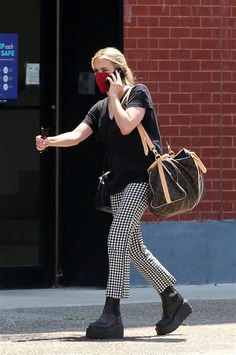 Emma Roberts Wears Checkered Pants And Black Tee As She Steps Out Carrying A Louis Vuitton