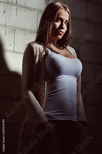 Beautiful Woman Posing Against A Wall Stock Photo And Royalty Free