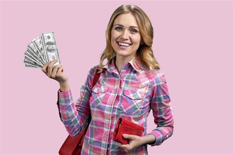 Premium Photo Young Happy Woman Holding Paper Money Standing On Color