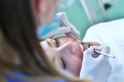 Close Up Of Female With Open Mouth During Oral Checkup At The Dentist