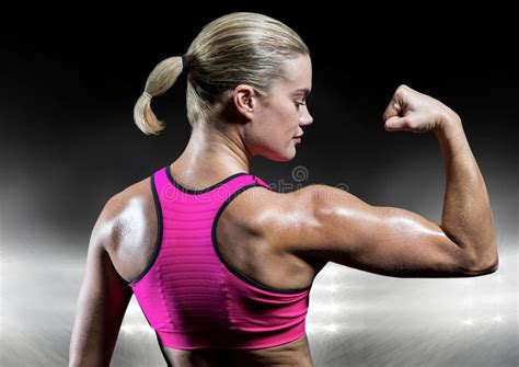 Strong Beautiful Fitness Woman Flexing Her Arm And Back Muscles Stock