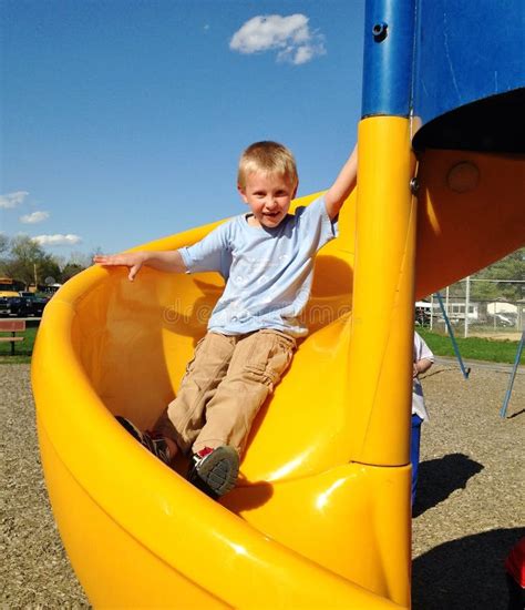 Boy Sliding Down A Slide At The Park Stock Image Image Of Daytime