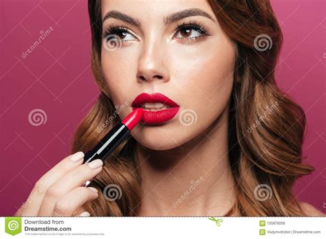 Portrait Of Serious Lady Painting Her Lips With Red Lipstick Isolated