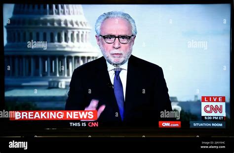 A Tv Screenshot Of Cnn News Anchor Wolf Blitzer Reporting Breaking News