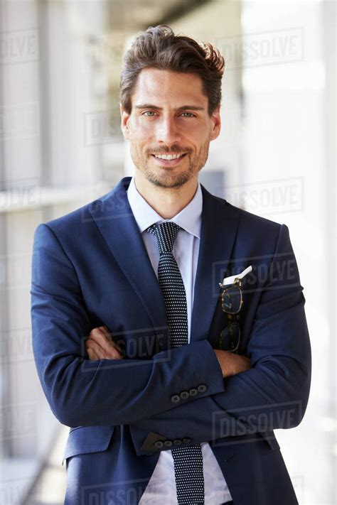 Portrait Of Young Professional Man In Suit Arms Crossed Stock Photo