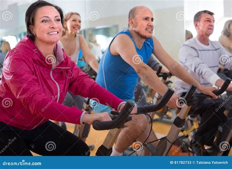 Mature Males And Females On Exercise Bikes In The Gym Stock Image Image Of Indoors Activities