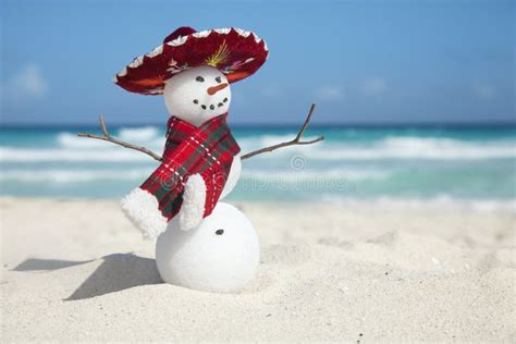Miniature Snowman Wearing Mexican Sombrero And Scarf On The Beach Stock