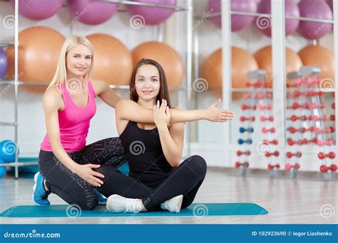 Young Woman Exercising With Her Fitness Instructor Stock Photo Image