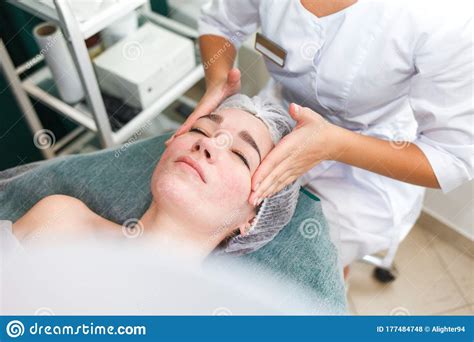 Doctor Beautician Makes Cosmetic Facial Massage Woman Relaxes On A