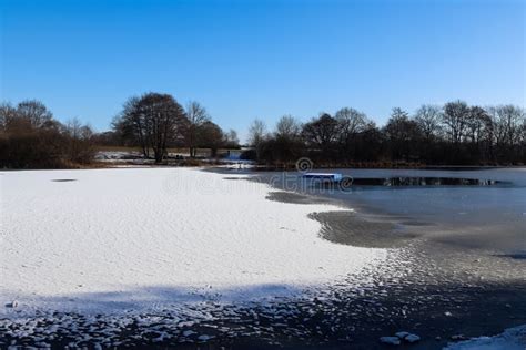 Snow Covered Frozen Lake Landscape In Northern Europe On A Sunny Day