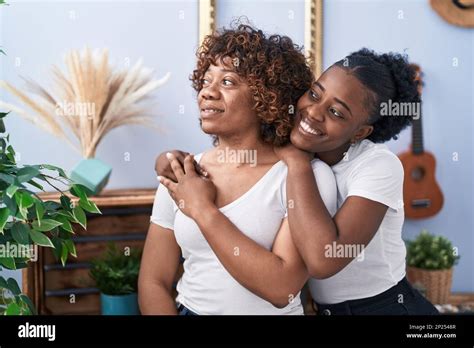 African American Women Mother And Daughter Hugging Each Other At Home Stock Photo Alamy