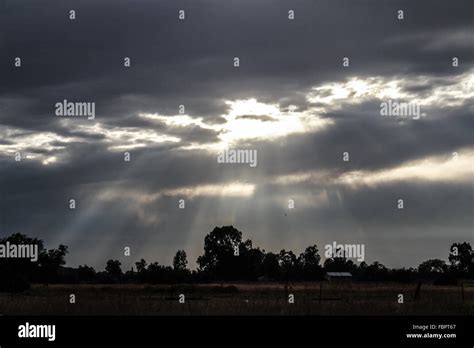 Sun Rays Breaking Through Clouds Across The Plains Stock Photo Alamy
