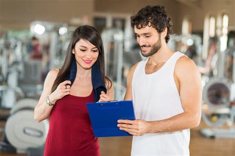Premium Photo Personal Trainer Explaining An Exercise To A Woman