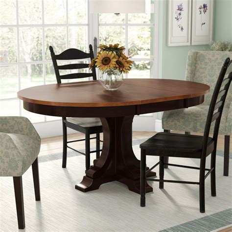 Solid wood round dining table and rattan woven chairs. Alisha Extendable Dining Table | Dining room design ...