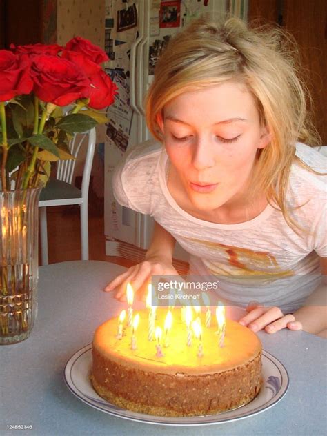 Girl Blowing Out Candles On Birthday Cake Photo Getty Images