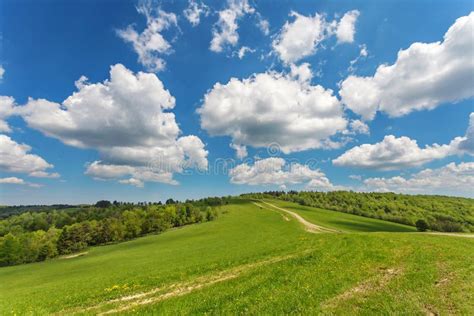 Blue Cloudy Sky Over Green Hills And Country Road Stock Image Image