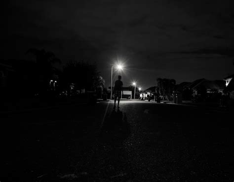 Free Photo Boy Walking Alone At Night Under The Street Lights