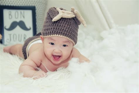 Download Very Cute Baby Wearing Beanie Hat Wallpaper