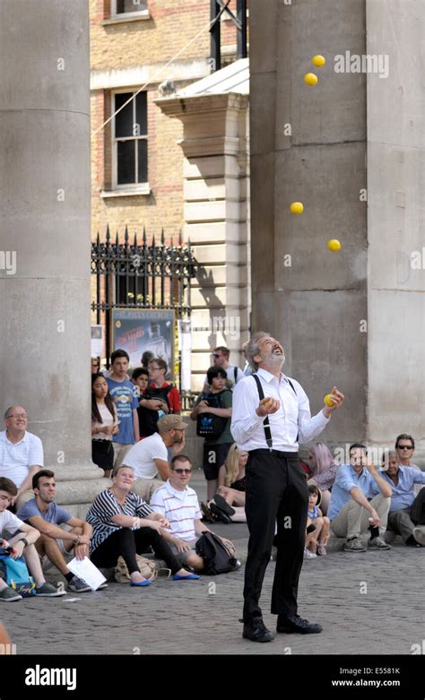 London England Uk Juggler Busking In Covent Garden Stock Photo Alamy
