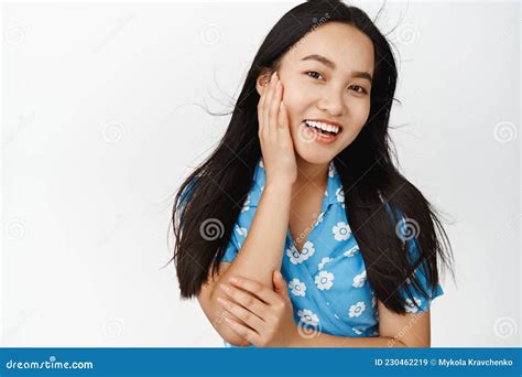 skin care and women beauty attractive brunette asian girl touching her face and smiling