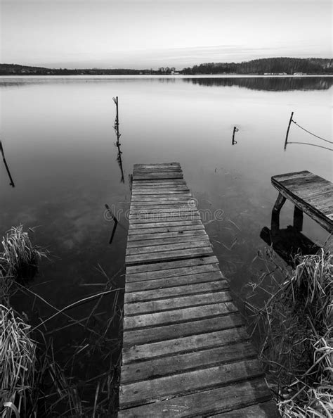 Black And White Lake Landscape With Small Wooden Pier Stock Image