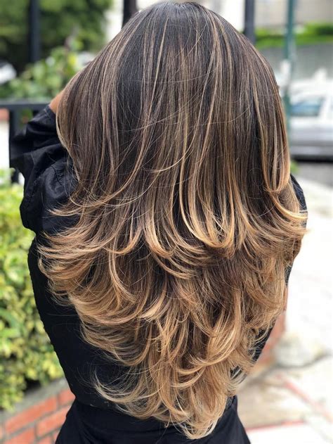 What keeps this hairstyle from looking juvenile, is the curls that start mid shaft and flow to the ends for a super soft feminine look. Trendy Hairstyles and Haircuts for Long Layered Hair To ...