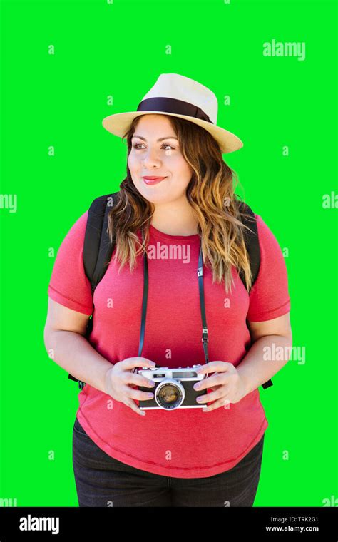 Latina Millennial Woman Holds An Old Camera While Travelling And