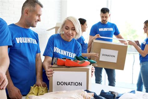Team Of Volunteers Collecting Donations In Boxes Stock Photo Image Of