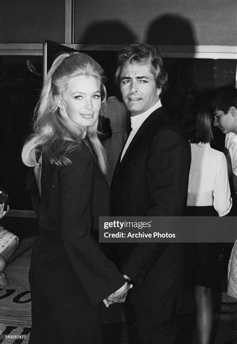 Actor John Derek And His Wife Linda Evans Holding Hands At The Emmy