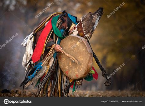 Mongolian Shaman Performing A Ritual — Stock Photo © Kertuee 314664228