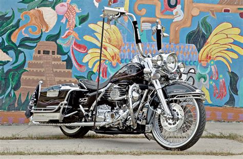 Chicano style, that's pure mexican style with giant apehanger handlebars, exhaust systems twice as long as the bike (and usually laf!) and awesome glittering paint jobs that require sunglasses to watch. 1999 Harley Davidson Road King - Paying Respect - Lowrider