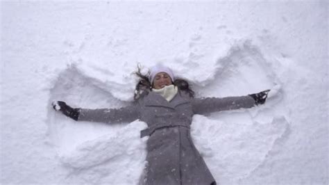 Woman Making Snow Angels — Stock Video © Prostock 32118839