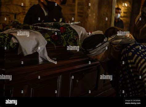 People attend the farewell ceremony held for the deceased Greek