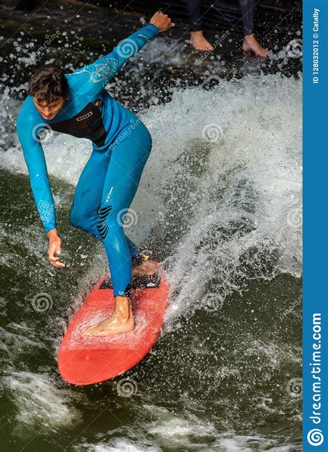 Man surfing in the waves of the eisbach river in munich. Surfing On The Eisbach River - Englischer Garten Munich ...