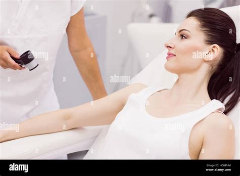 Dermatologist Examining Skin Of Patient With Dermatoscope Stock Photo