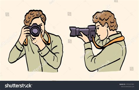 Portrait Of Man Photographer Cameraman Holding Camera In His Hands