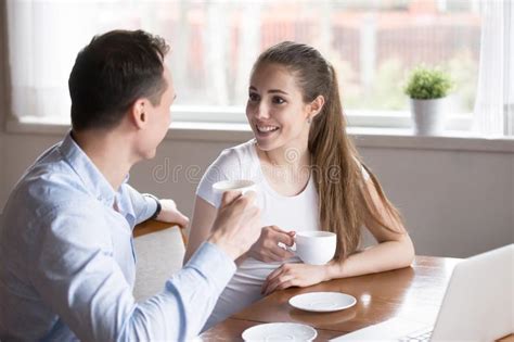 Spouses Talking And Drinking Morning Coffee In The Kitchen Stock Photo