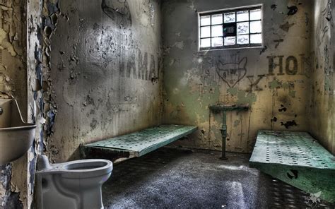Dynamic View Of Old Prison Cell With Door Bed Clothes Hoodoo Wallpaper