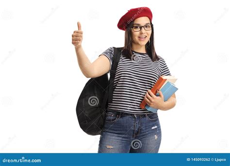 Female Student Holding Books And Giving Thumbs Up Stock Photo Image