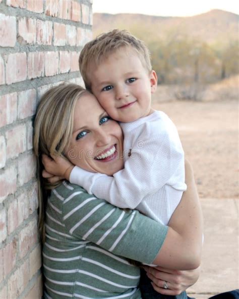 Mother And Son Hugging A Young Happy Mother Getting A Hug From Her Son