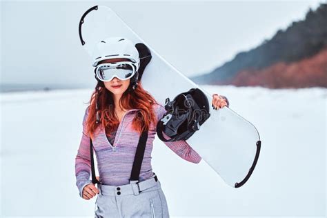 Portrait Of A Beautiful Redhead Girl In Protective Helmet And Goggles