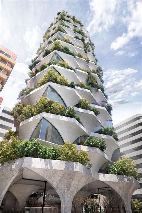 A Very Tall Building With Plants Growing On Its Sides