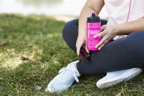 Tired Woman Drinking Water After Hard Workout Stock Photo By Gpointstudio