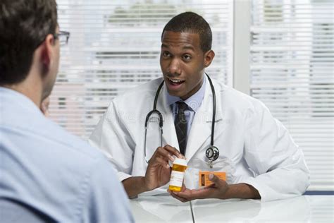 African American Doctor Consulting With Patient Horizontal Stock Photo