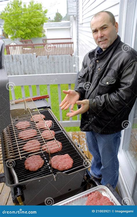 Man Cooking Hamburgers On A Bbq Stock Image Image Of Serious People