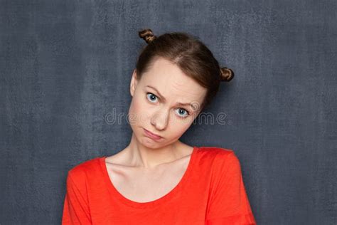 Portrait Of Upset Disappointed Woman With Apologetic Expression Stock