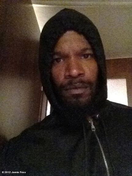 A Man Wearing A Hoodie Is Looking At The Camera