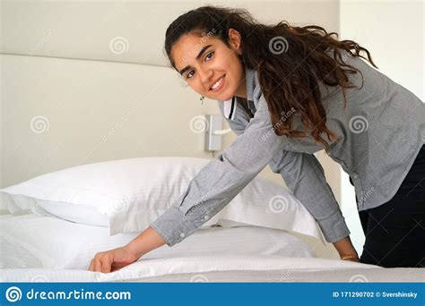 Maid Making Bed In Hotel Room Housekeeper Making Bed Stock Photo