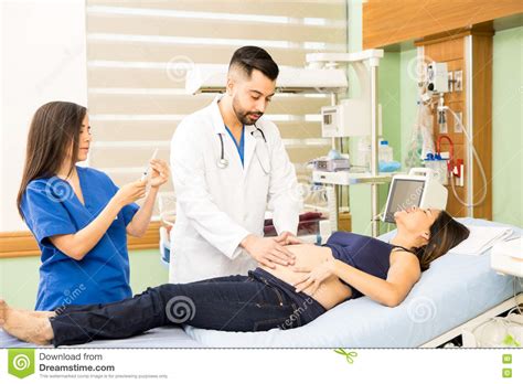 Doctors Taking Care Of Pregnant Woman Stock Image Image Of Coat